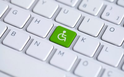 Accessibility disability computer icon. Green key with wheelchair icon on white laptop keyboard. Accessibility disability computer symbol