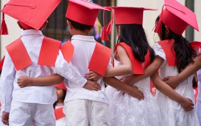 Latin pre primary children students embracing together after their graduation to get into elementary school